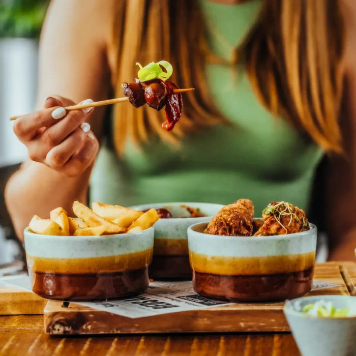 Sharing plates of chicken wings and chips with a glass of white wine at The Hercules Pillars, Holborn