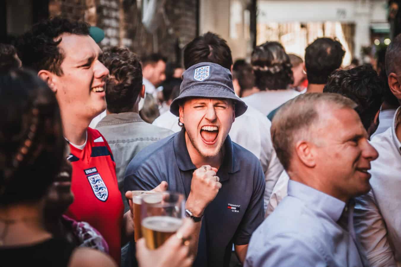 England fans celebrating with pints outside St Christopher's Pub on Borough High Street, London Bridge