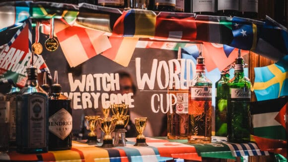 The bar at St Christopher's Pub decorated with international flags and trophies for a World Cup live screening event