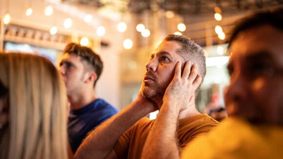 Group of friends watching a sports event at St Christopher's Pub.